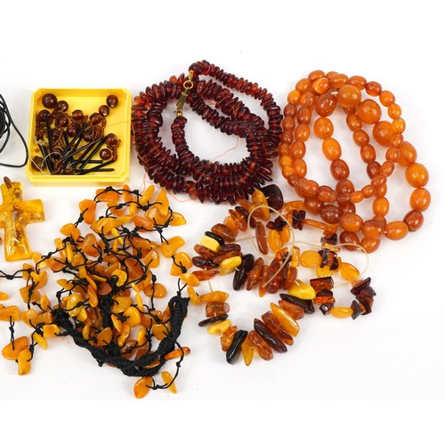 2647 - Five amber coloured necklaces, three bracelets and a cross pendant, total weight 196.0g