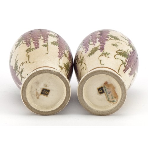 98 - Pair of Japanese Satsuma pottery vases   raised on hardwood stands each hand painted with wisteria, ... 