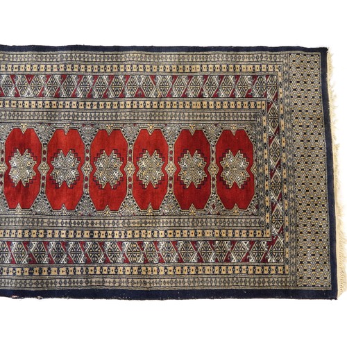 1035 - Rectangular red and blue ground rug with all over geometric design, 165cm x 92cm