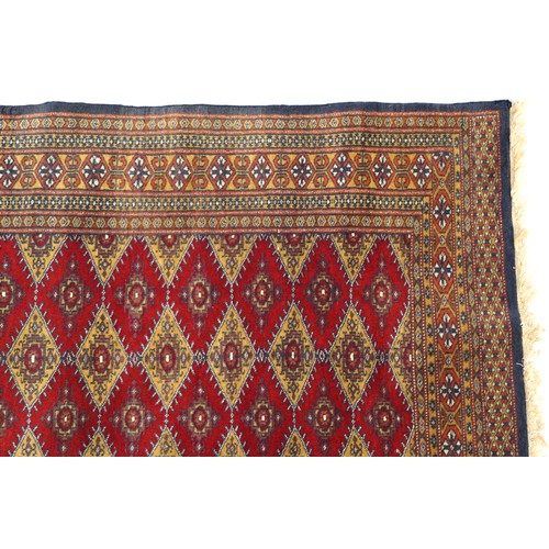 1069 - Rectangular red and blue ground rug with all over geometric design, 145cm x 91cm