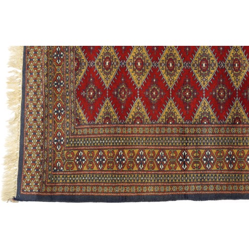 1069 - Rectangular red and blue ground rug with all over geometric design, 145cm x 91cm