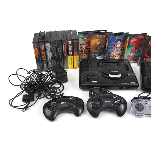 1168 - Two Sega Mega Drive games consoles with controllers and a selection of games