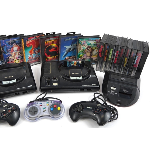 1168 - Two Sega Mega Drive games consoles with controllers and a selection of games