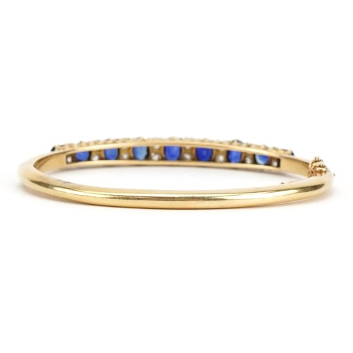 2020 - Victorian unmarked gold sapphire and diamond hinged bangle set with nine graduated sapphires and six... 