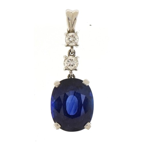 2031 - Unmarked platinum drop pendant set with a large cushion shaped sapphire weighing over 8ct and two ro... 