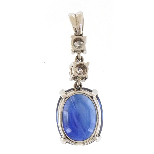 2031 - Unmarked platinum drop pendant set with a large cushion shaped sapphire weighing over 8ct and two ro... 