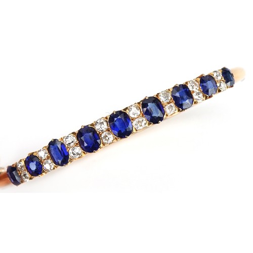 2020 - Victorian unmarked gold sapphire and diamond hinged bangle set with nine graduated sapphires and six... 