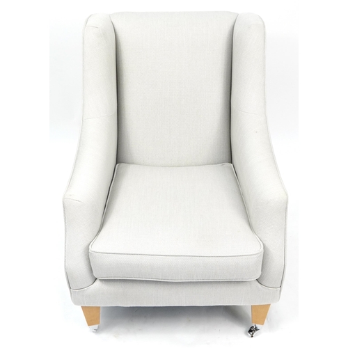 1065A - Contemporary wingback style armchair with light wood feet and chrome casters