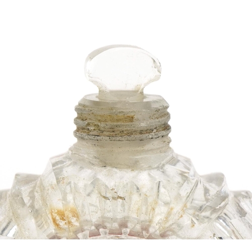 55 - Circular cut glass scent bottle with unmarked silver lid and stopper, 6.5cm high