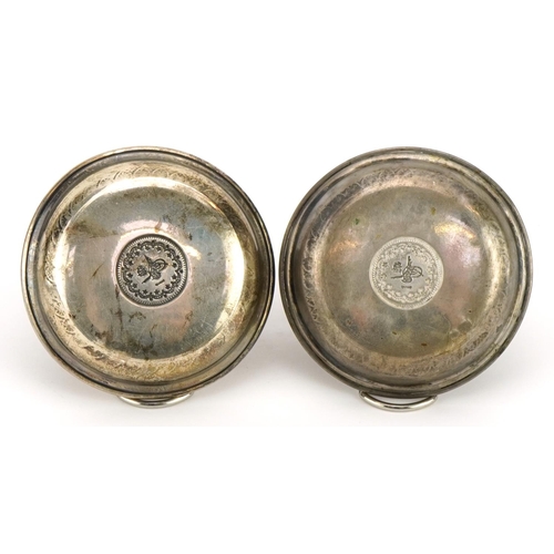 304 - Pair of Persian circular 800 grade coin set silver dishes, 7cm in diameter, 28.2g