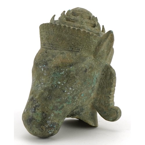 313 - Chino Tibetan patinated bronze head of a mythical animal, 16.5cm high