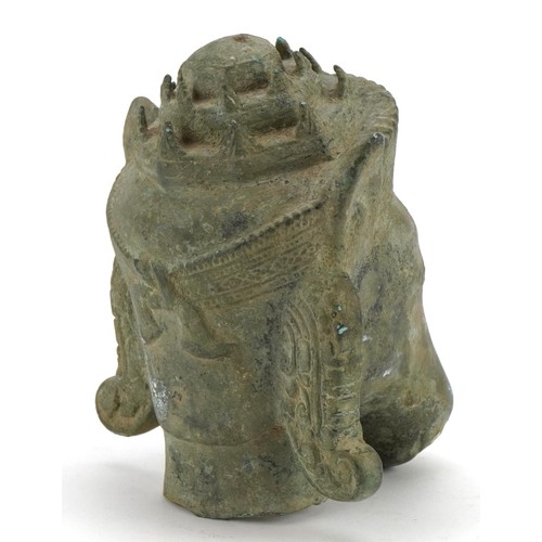 313 - Chino Tibetan patinated bronze head of a mythical animal, 16.5cm high