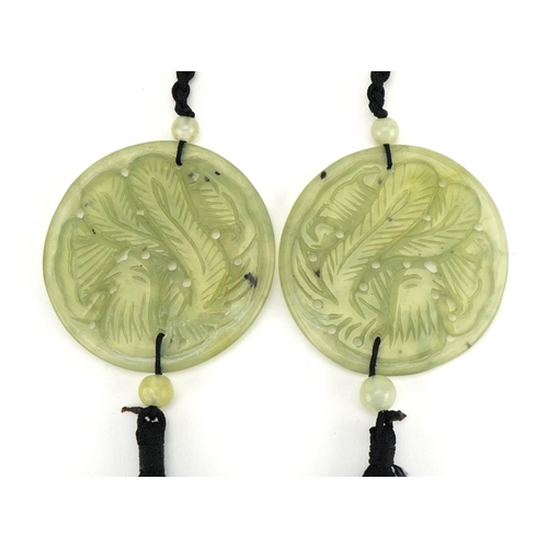 1279 - Two Chinese jade pendants carved with flowers, each pendant 6cm in diameter