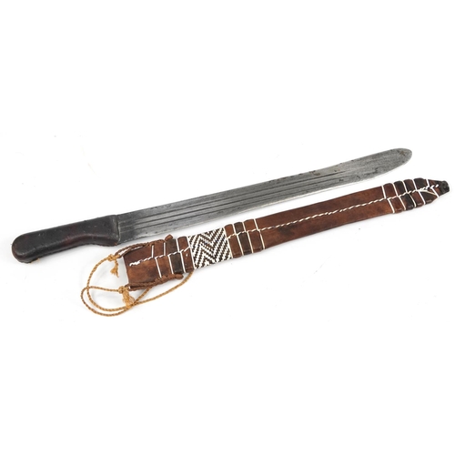 2200 - Asian hunting knife with steel blade and leather sheath, 61cm in length