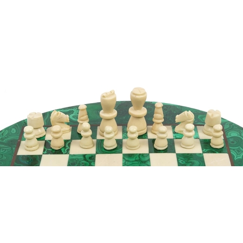 2002 - Circular malachite and onyx chess set with chess pieces, the largest chess pieces each 6cm high, the... 