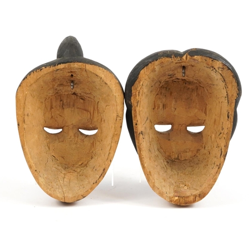 285 - Two early 20th century African tribal interest carved wood face masks from Nigeria, the largest 29cm... 