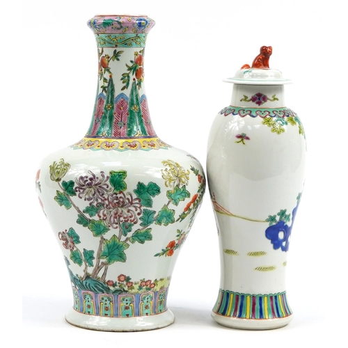 555A - Two Chinese porcelain vases including a baluster lidded example hand painted in the famille rose pal... 