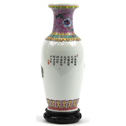 552 - Chinese porcelain vase with carved hardwood stand decorated with a peacock amongst cherry blossom, c... 