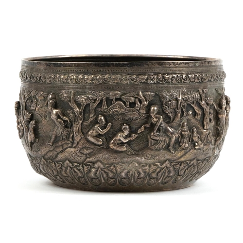 52 - Large Burmese silver bowl profusely embossed with figures and wild animals, 23cm in diameter, 1254g