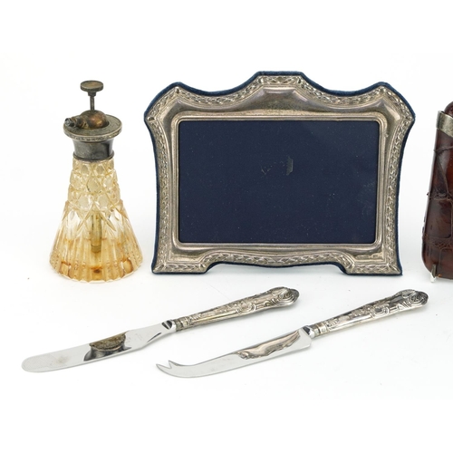 94 - Silver items including a Victorian silver mounted leather cigar case, easel photo frame and atomiser... 