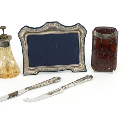 94 - Silver items including a Victorian silver mounted leather cigar case, easel photo frame and atomiser... 