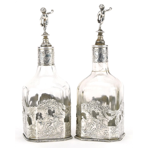 144 - Pair of Dutch silver mounted square glass bottles, pierced and embossed with courting couples and Pu... 