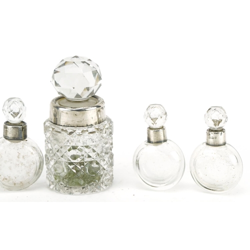 391 - Five Victorian and later silver mounted scent bottles and a cut glass bottle with stopper, the Victo... 