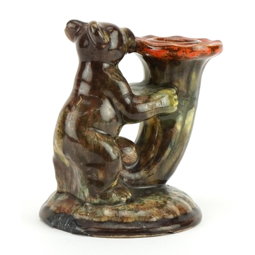 250 - German Art Deco candlestick in the form of a bear holding a cornucopia having a mottled glaze, impre... 