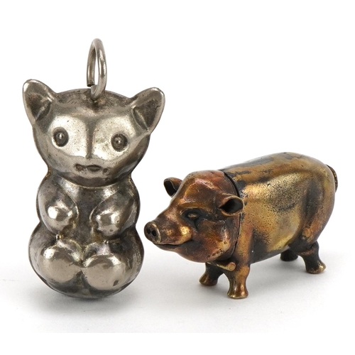 1285 - Novelty brass vesta case in the form of a pig and a silver plated baby's rattle in the form of a cat... 