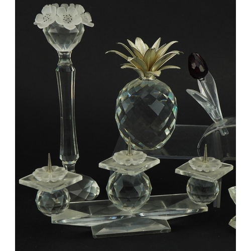 1153 - Six Swarovski Crystal sculptures including three branch candleholder, set of three coloured flowers,... 