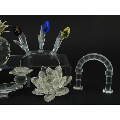 1153 - Six Swarovski Crystal sculptures including three branch candleholder, set of three coloured flowers,... 