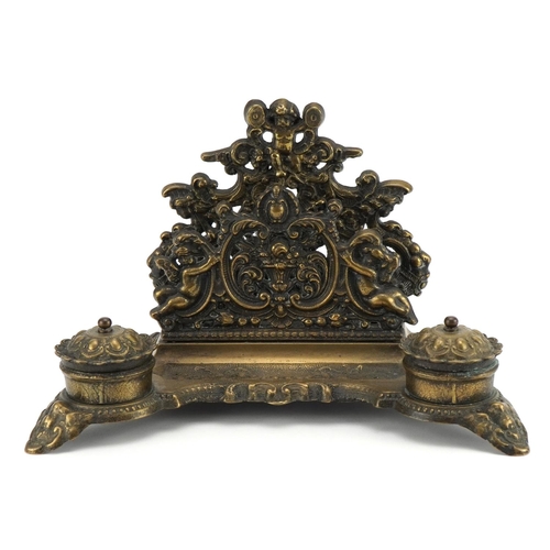 1283 - 19th century style brass desk stand decorated with Putti with letter rack and pair of inkwells, 30cm... 