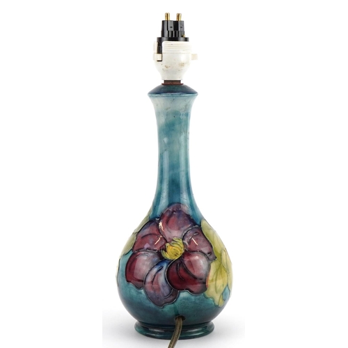 152 - Moorcroft pottery table lamp hand painted in the Clematis pattern, 28.5cm high