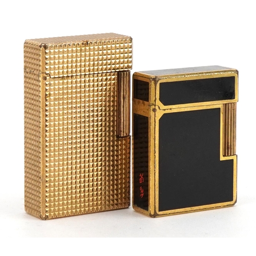 108 - Two S T Dupont gold plated pocket lighters including a black enamelled example with Chinese characte... 