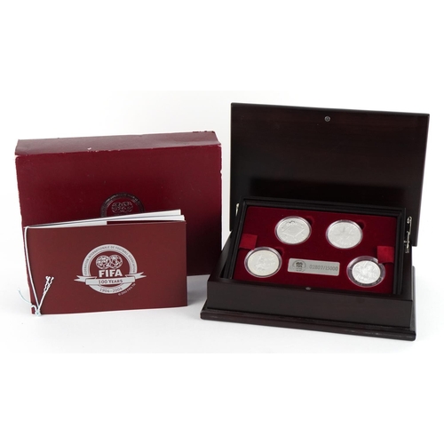 2468 - Footballing interest silver four coin collection housed in a wooden case honouring the FIFA Centenni... 