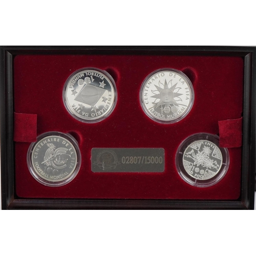 2468 - Footballing interest silver four coin collection housed in a wooden case honouring the FIFA Centenni... 