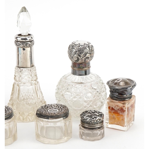 392 - Eight Victorian and later silver mounted cut glass scent bottles and jars, the largest 14cm high