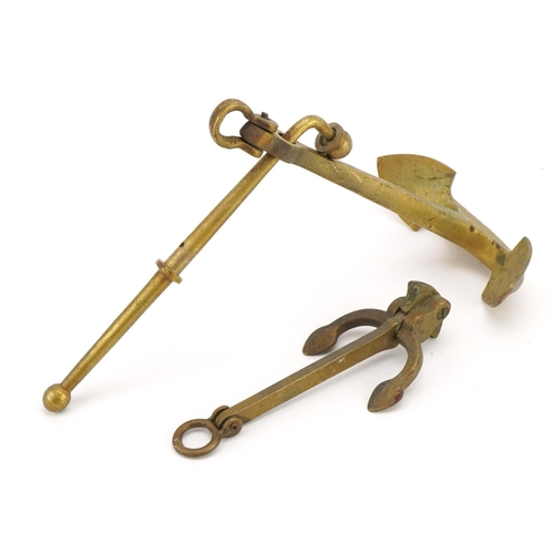 415 - Two shipping interest brass anchors, the largest 24.5cm high