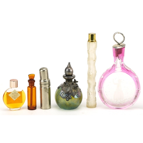 390 - Vintage and later scent bottles including a cranberry overlaid glass example etched with a female, g... 