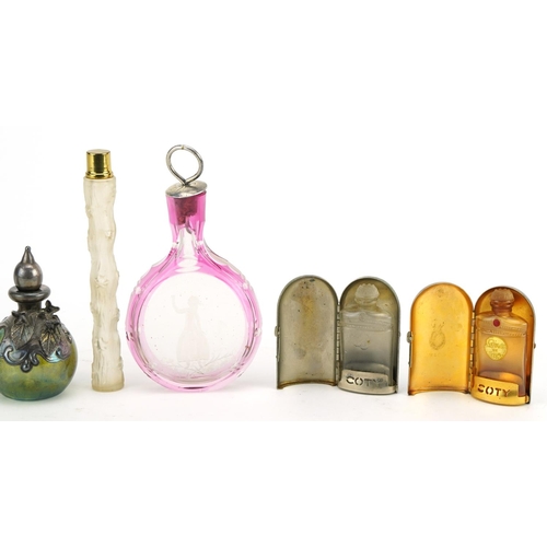 390 - Vintage and later scent bottles including a cranberry overlaid glass example etched with a female, g... 