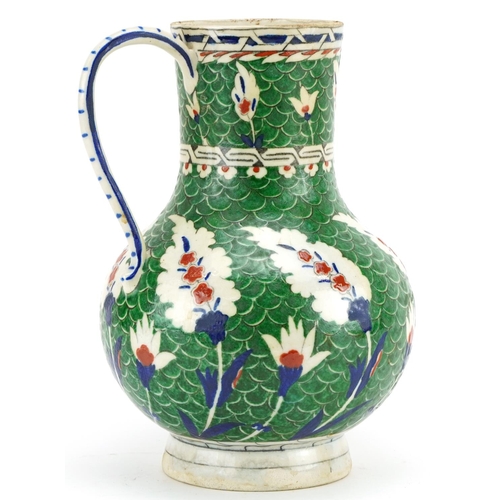 190 - Turkish Iznik Ottoman water jug hand painted with stylised leaves onto a green ground, 26cm high