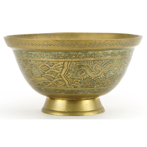 1250 - Chinese bronzed footed bowl engraved with dragons, character marks to the base, 26.5cm in diameter