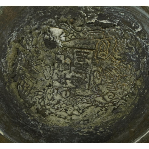 1250 - Chinese bronzed footed bowl engraved with dragons, character marks to the base, 26.5cm in diameter