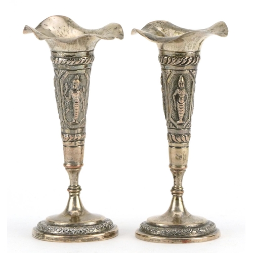 305 - Pair of Anglo Indian white metal trumpet bud vases embossed with deities, 11.2cm high