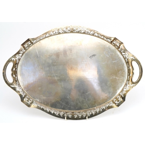 330 - Heavy oval silver serving tray with twin handles and pierced gallery, indistinct hallmarks, engraved... 