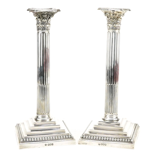 184 - William Hutton & Sons Ltd, pair of Edwardian military interest silver Corinthian column candlesticks... 