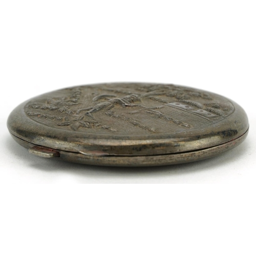 301 - Anglo Indian sterling silver circular compact embossed with a farmer, 7.5cm in diameter, 93.6g