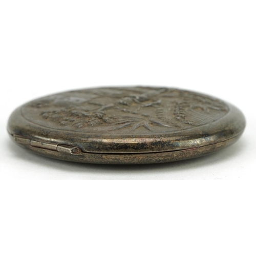 301 - Anglo Indian sterling silver circular compact embossed with a farmer, 7.5cm in diameter, 93.6g