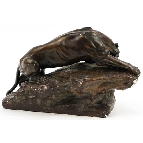 379 - French Art Deco bronzed plaster sculpture of a lion on rock, signed Berce, 47cm in length