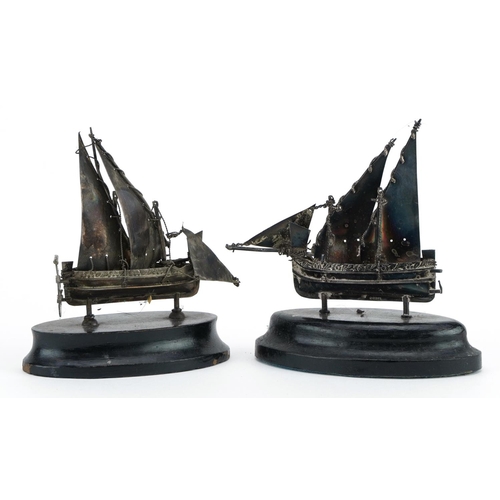 53 - Two Maltese miniature silver sailing boats raised on ebony bases, the largest 10cm high